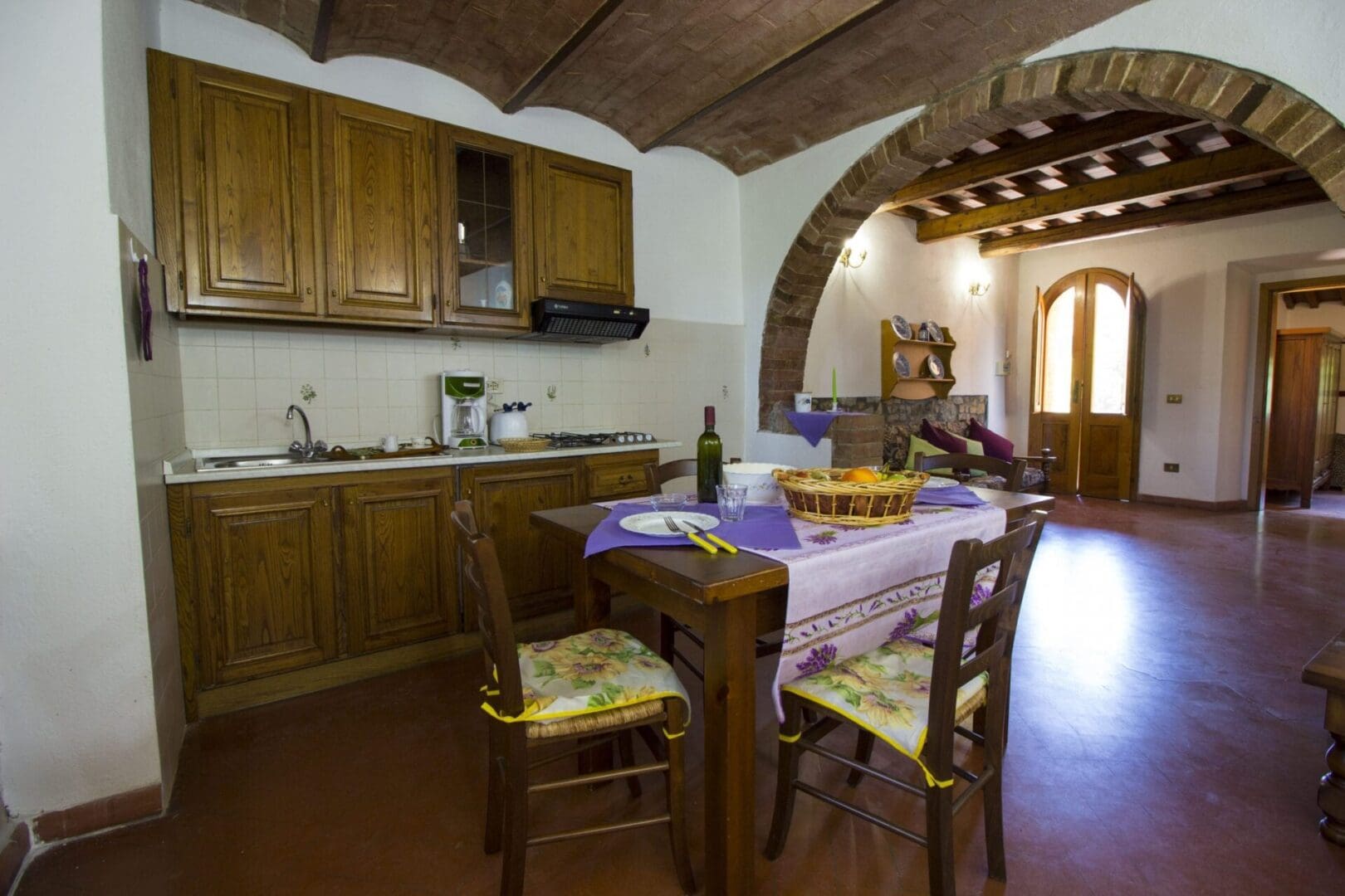 A kitchen with wooden cabinets and table in it