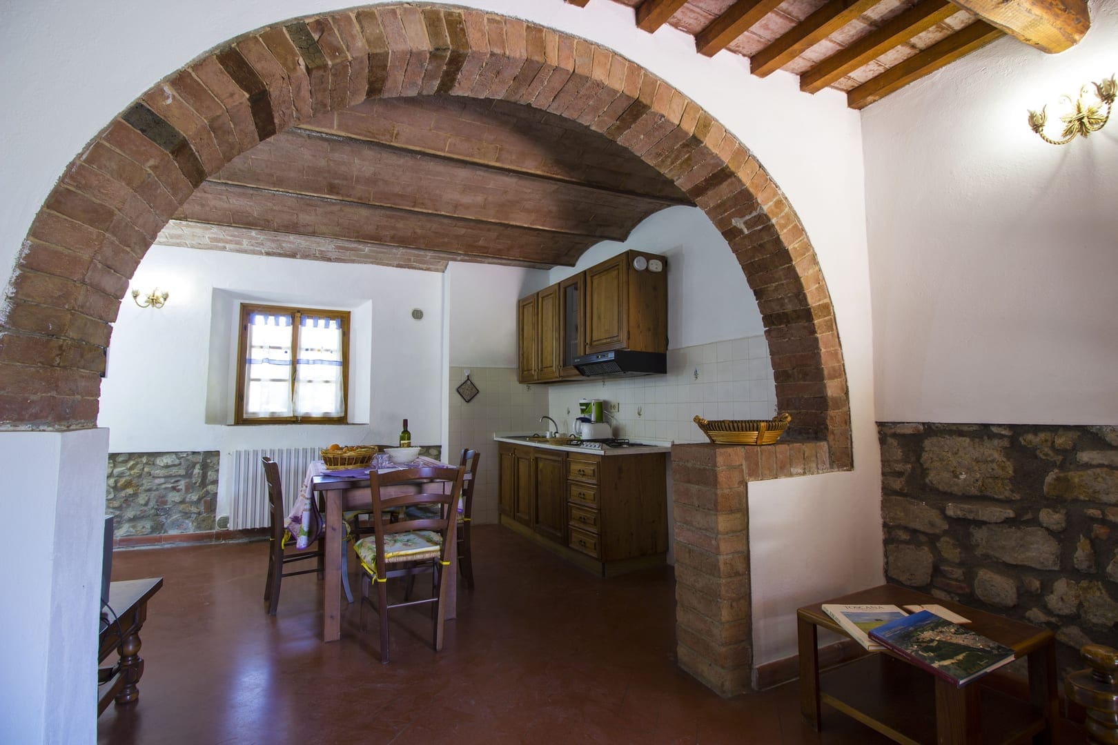 A kitchen with an arch in the middle of it