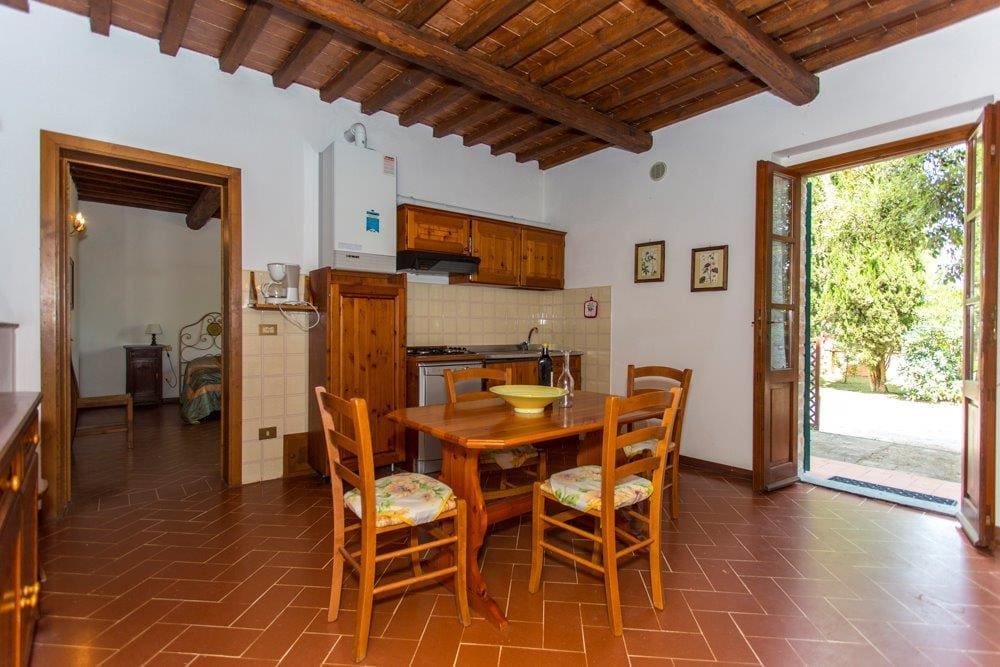 A dining room with wooden chairs and table