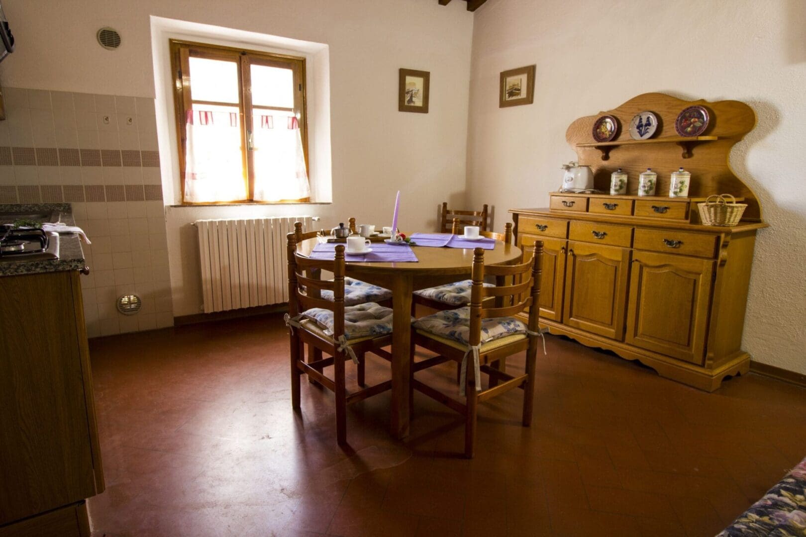 A dining room with wooden furniture and wood floors.