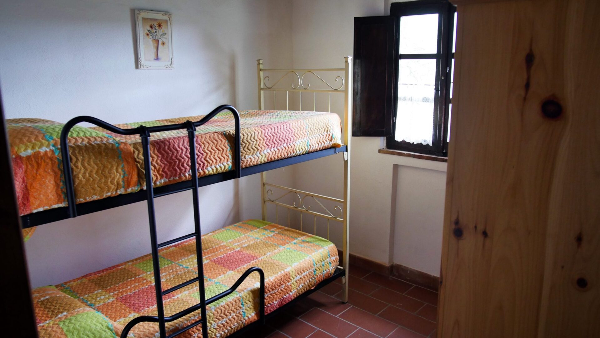 A room with two bunk beds and a window.