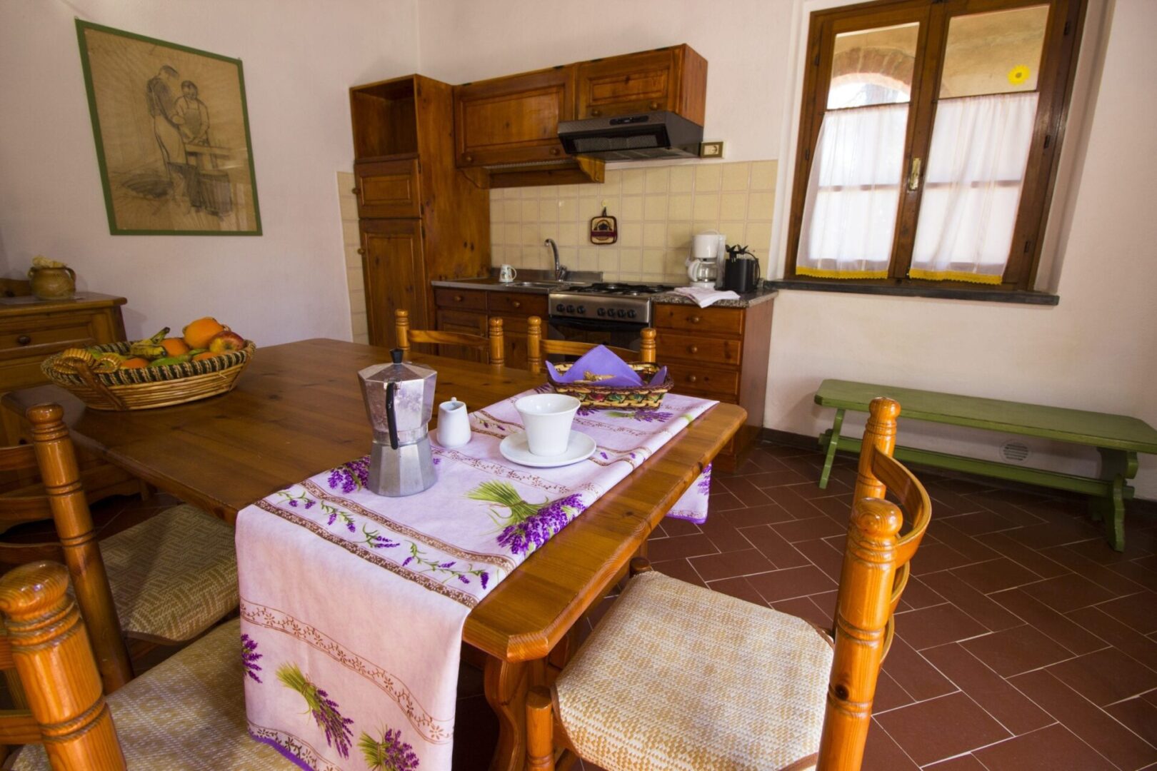 A kitchen with a table and chairs, a stove and a microwave.