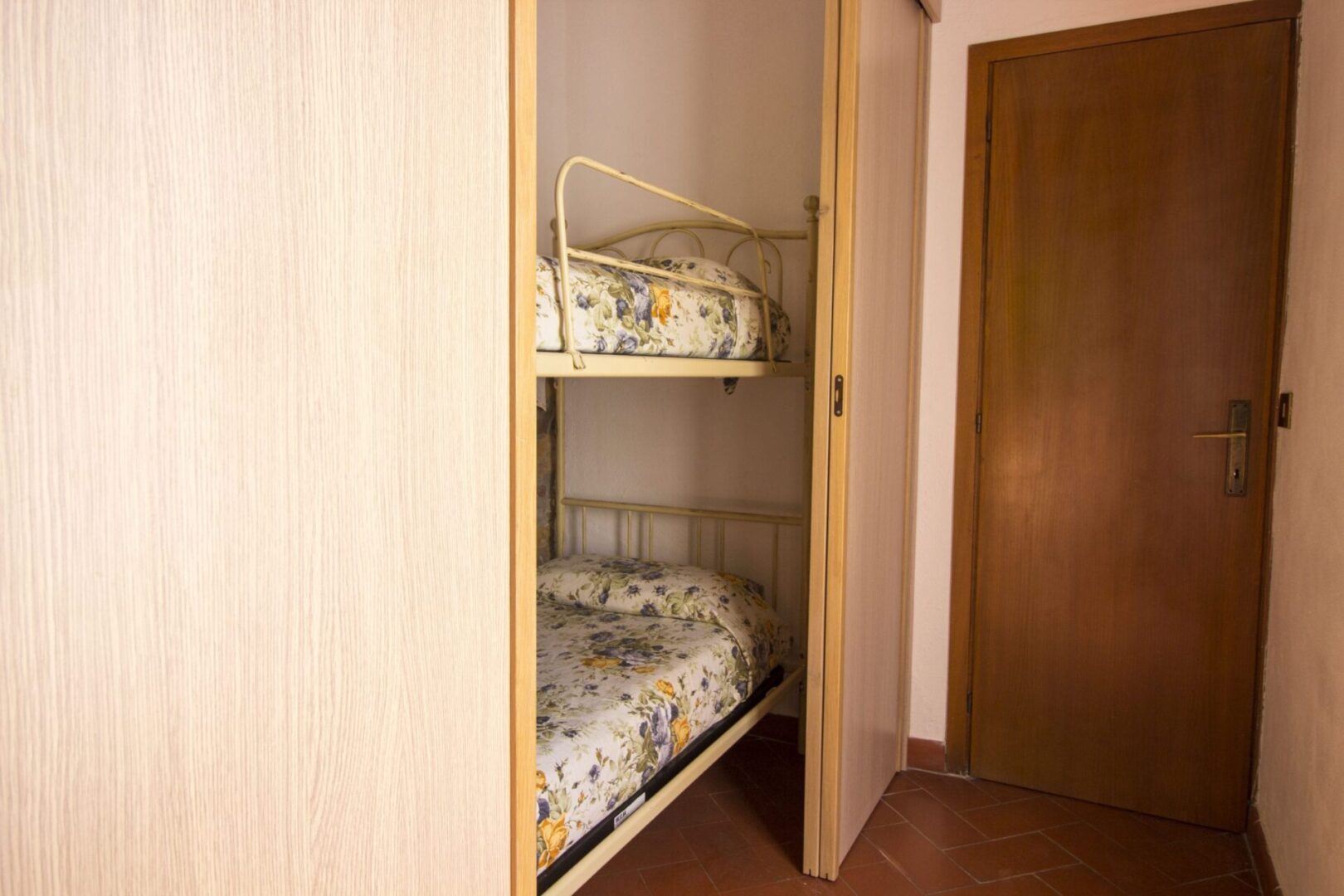 A room with two beds and a door.