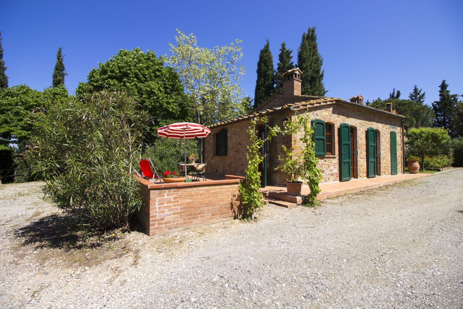 A brick building with a red umbrella on the front.