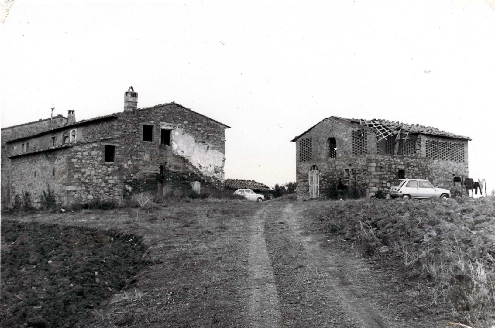 A black and white photo of two old houses