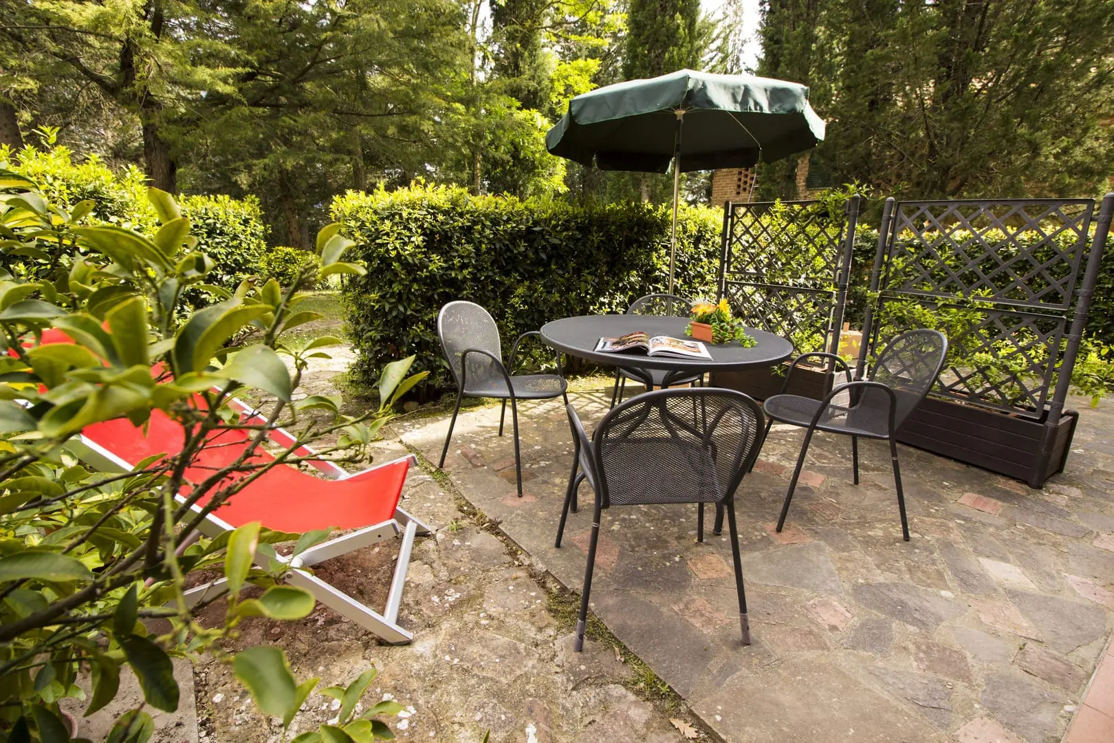 A patio set with an umbrella and chairs.