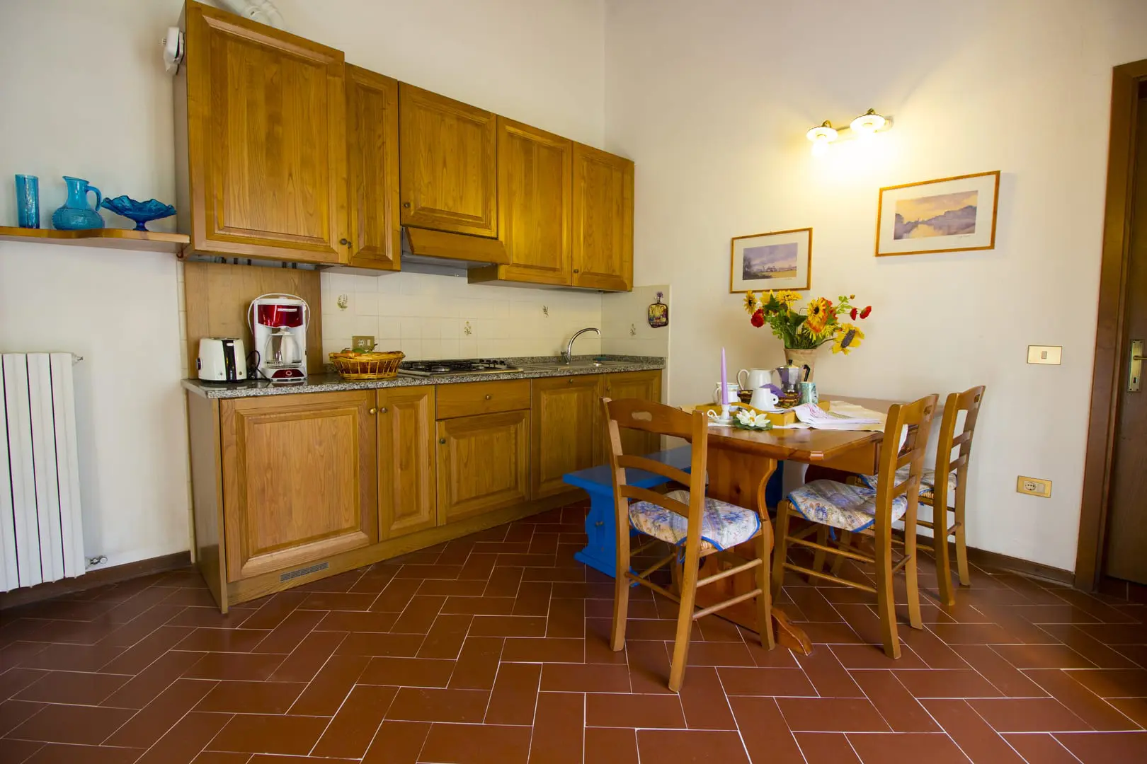 A kitchen with wooden cabinets and a table