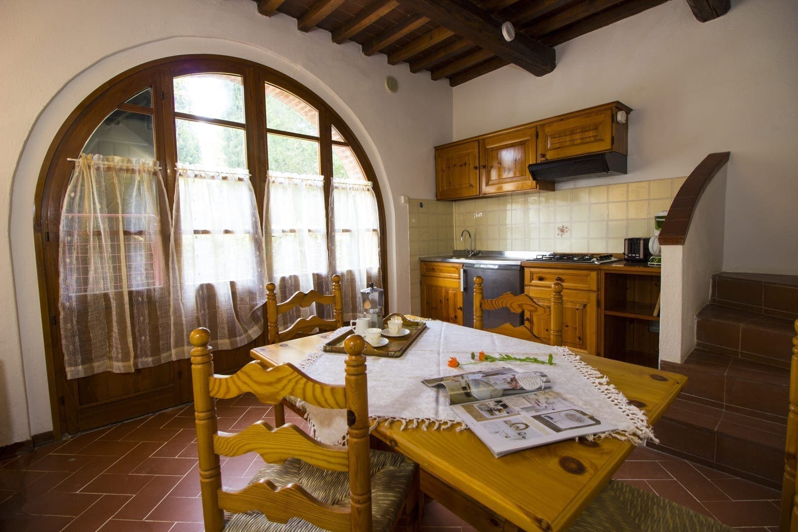 A kitchen with a table and chairs in it