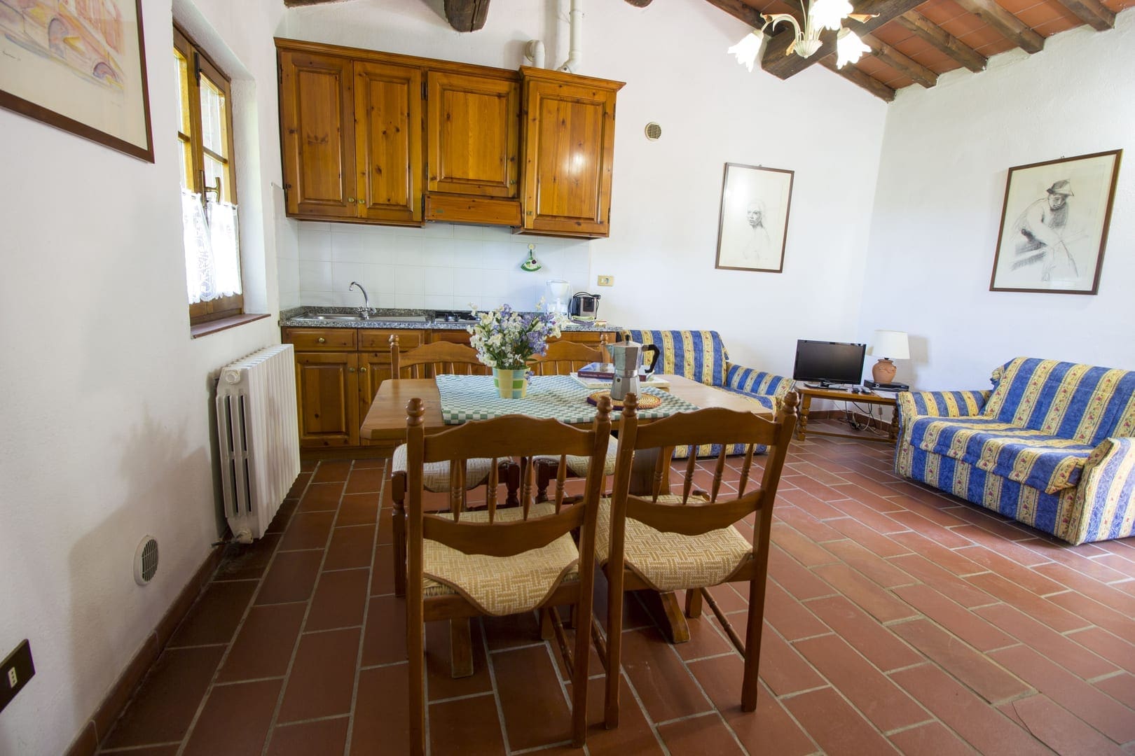 A kitchen with wooden furniture and a table